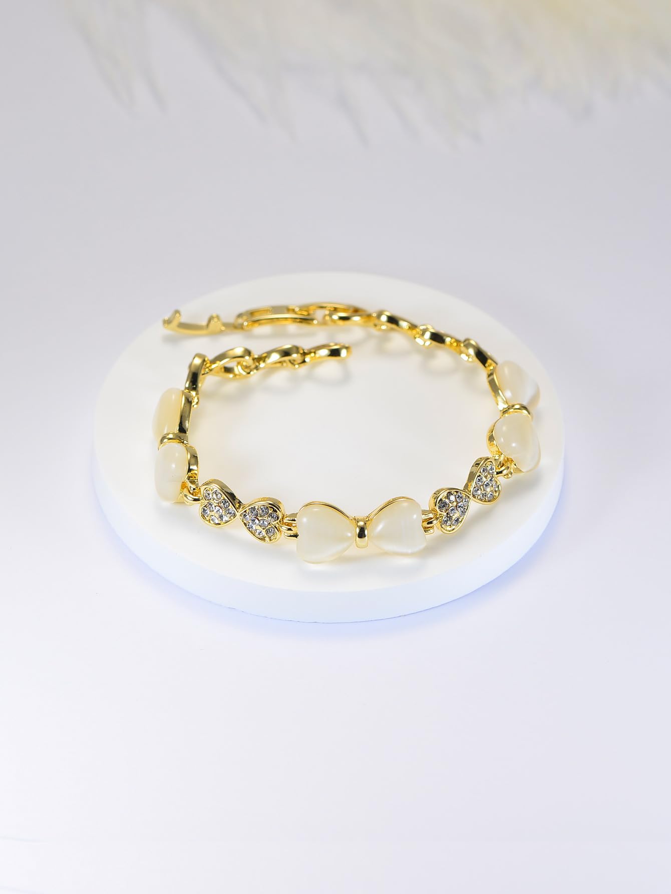 ハート＆リボンの猫目石ブレスレット｜ジルコニア×ローズゴールド＆ゴールド